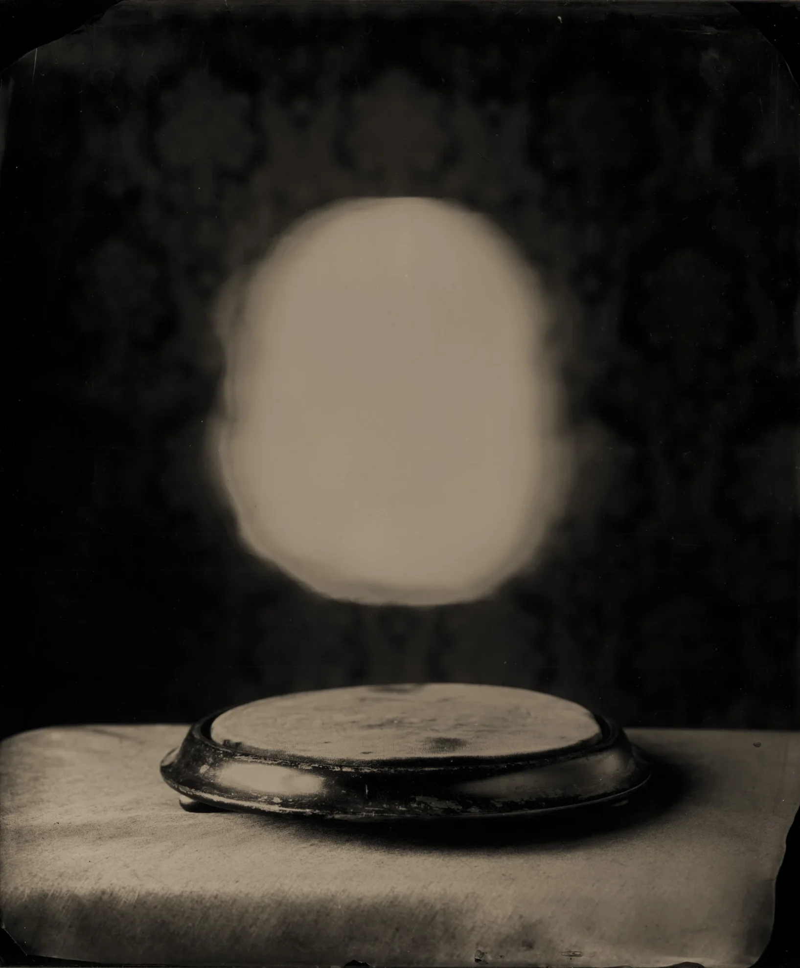 This image depicts a photograph by artist Ben Cauchi titled 'Photism', an artwork made in 2006. The medium is ambrotype. The size of this artwork is 43x36 cm. This artwork was first shown in the exhibition 'The Hermetic Seal' at Ray Hughes Gallery in 2006. This artwork is in the collection of the Art Gallery of New South Wales in Sydney, Australia.